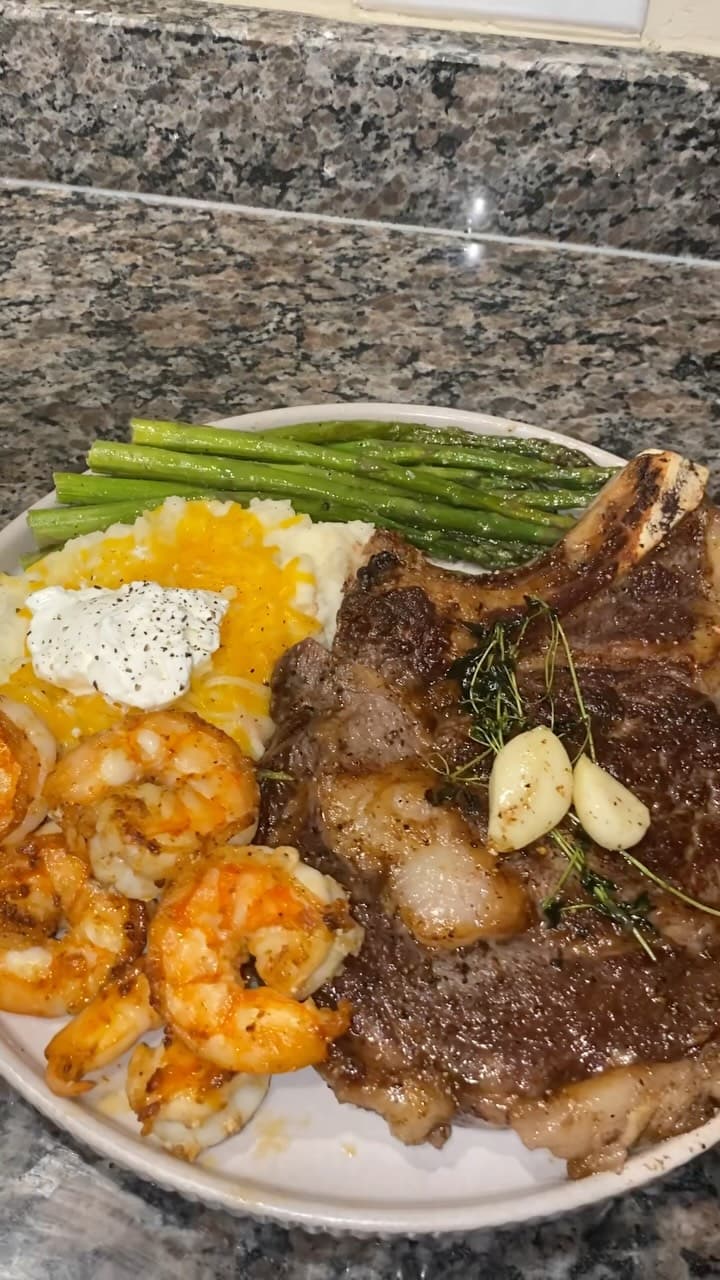Bone‑in Ribeye Steak with Cajun Shrimp, Garlic‑Butter Mash, and Herb Asparagus