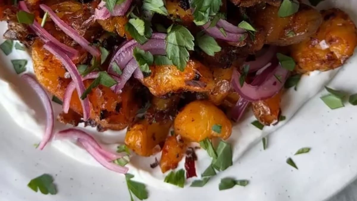 Crispy Smashed Harissa Potatoes with Garlicky Yogurt, Pickled Onions, and Parsley