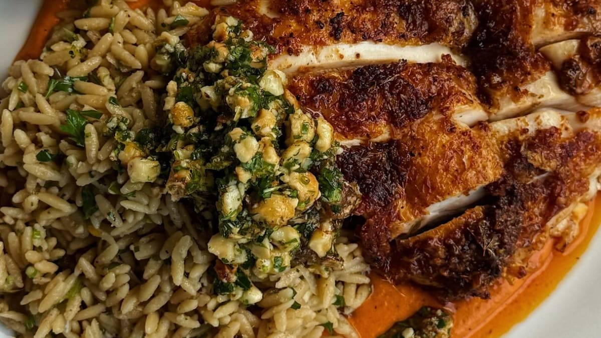 Lemon Crispy Chicken with Herby Orzo, Romesco & Candied Hazelnut Gremolata
